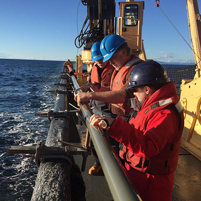 Photograph of scientists recovering a core aboard the Canadian Coast Guard vessel John P. Tully.